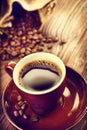 Cup of aromatic coffee on saucer over wooden table Royalty Free Stock Photo