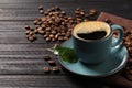 Cup of aromatic hot coffee and beans on black wooden table, space for text Royalty Free Stock Photo