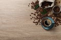 Cup of aromatic hot coffee and beans on wooden table, flat lay. Space for text Royalty Free Stock Photo