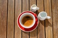 Cup of aromatic hot coffee, milk and water on wooden table, flat lay Royalty Free Stock Photo