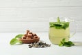 Cup with aromatic mint tea, dry leaves and sugar cubes on table Royalty Free Stock Photo