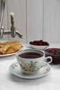 Cup of aromatic tea and treats on table Royalty Free Stock Photo