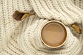 Cup of autumn coffee, tea or hot chocolate, fall leaves on a warm scarf. Drink for autumn cold rainy days. Sunday