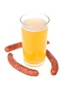 Cup of beer and grilled sausages isolated