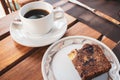 Cup of black coffee and banana bread loaf. Breakfast in hotel. Morning dessert. Hot beverage with pastry. Espreso with biscuit. Royalty Free Stock Photo