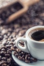Cup of black coffee with beans on wooden table Royalty Free Stock Photo