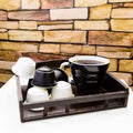 A cup of black coffee with capsules for coffeemachine on stone b