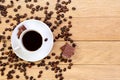 Cup of black coffee, chocolate and coffee beans on a wooden back