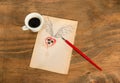 Cup of black coffee with coffee beans heart with wings drawn in pencil and red rose . Royalty Free Stock Photo