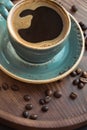 Cup of black coffee with coffee beans on wooden tray. Royalty Free Stock Photo