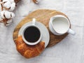 Cup of black coffee with croissant and milk on  table. Royalty Free Stock Photo