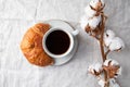 Cup of black coffee with croissant on  table. The concept of breakfast, flat lay, top view Royalty Free Stock Photo