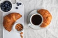 Cup of black coffee with croissant on  table. Royalty Free Stock Photo