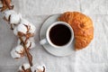 Cup of black coffee with croissant on  table. Royalty Free Stock Photo