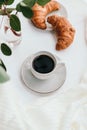 Cup of black coffee with croissant on white  table. Royalty Free Stock Photo