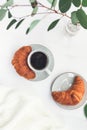 Cup of black coffee with croissant on white table Royalty Free Stock Photo