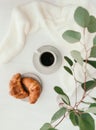 Cup of black coffee with croissant on white  table. Royalty Free Stock Photo