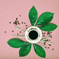 Cup of black coffee with flowers on pink coloured art background. Good Morning coffee.