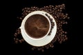 Cup of black coffee with foam on background of roasted coffee be Royalty Free Stock Photo