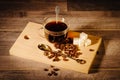 A cup of black coffee with lumps of sugar and coffee beans Royalty Free Stock Photo