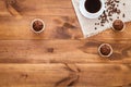 Cup of black coffee, muffins and coffe beans scattered on brown wooden table, cofee cafe cafeteria shop background, hot drink in Royalty Free Stock Photo