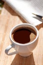 Cup of black coffee, newspaper and a pen Royalty Free Stock Photo