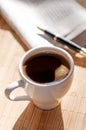 Cup of black coffee, newspaper and a pen Royalty Free Stock Photo