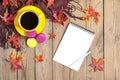 Cup with black coffee, pen, notepad, wooden table with autumn fallen orange leaves Flat lay Top view Mock Royalty Free Stock Photo