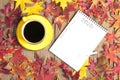 Cup with black coffee, pen, notepad, wooden table with autumn fallen orange leaves Flat lay Top view Mock Royalty Free Stock Photo