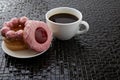 Cup of black coffee with pink donuts Royalty Free Stock Photo