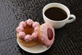 Cup of black coffee with pink donuts Royalty Free Stock Photo