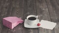 Cup of black coffee, pink paper bag and love Valentine`s day message with red heart shape Royalty Free Stock Photo