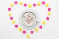 Cup of black coffee pink yellow roses laid out in the shape of a heart on a white background. Royalty Free Stock Photo