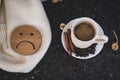 A cup of black coffee with a sad face. Concept of coffee harm, bad habit and caffeine addiction. Contrast black and