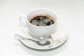 Cup of black coffee on a saucer with a napkin, a teaspoon and lumps of sugar Royalty Free Stock Photo