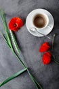 Cup of black coffee set with wild flowers - poppies, on grey grunge background Royalty Free Stock Photo