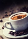 Cup of black coffee and spilled beans Royalty Free Stock Photo