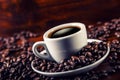 Cup of black coffee and spilled coffee beans. Royalty Free Stock Photo