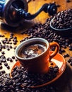 Cup of black coffee and spilled coffee beans. Royalty Free Stock Photo