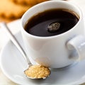 Cup of black coffee and spoon with brown sugar Royalty Free Stock Photo