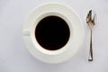 Cup of black coffee with spoon and saucer on table Royalty Free Stock Photo