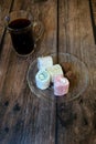 A cup of black coffee with a spoon on a wooden table and oriental sweets on a saucer. Close-up Royalty Free Stock Photo