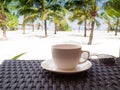 A cup of black coffee and sun glasses with coconut tree plan on white sand beach sea view background, Travel plans after Royalty Free Stock Photo