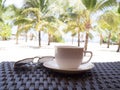 A cup of black coffee and sun glasses with coconut tree plan on white sand beach sea view background, Travel plans after Royalty Free Stock Photo