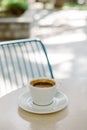 Cup of black coffee on a table in a street cafe. Selective focus Royalty Free Stock Photo