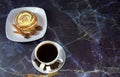 A cup of black coffee with two pieces of sugar and a plate with a cinnamon stick, decorated with coffee beans and anise Royalty Free Stock Photo