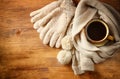 Cup of black coffee with a warm scarf on wooden background. filreted image