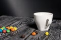 A cup of black coffee in a white cup. Chocolate candy in glaze. On pine boards Royalty Free Stock Photo