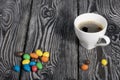 A cup of black coffee in a white cup. Chocolate candy in glaze. On pine boards Royalty Free Stock Photo