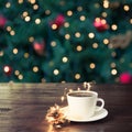 Cup of black coffee on wooden table in cafe. Christmas lights and gold garland on background. Royalty Free Stock Photo